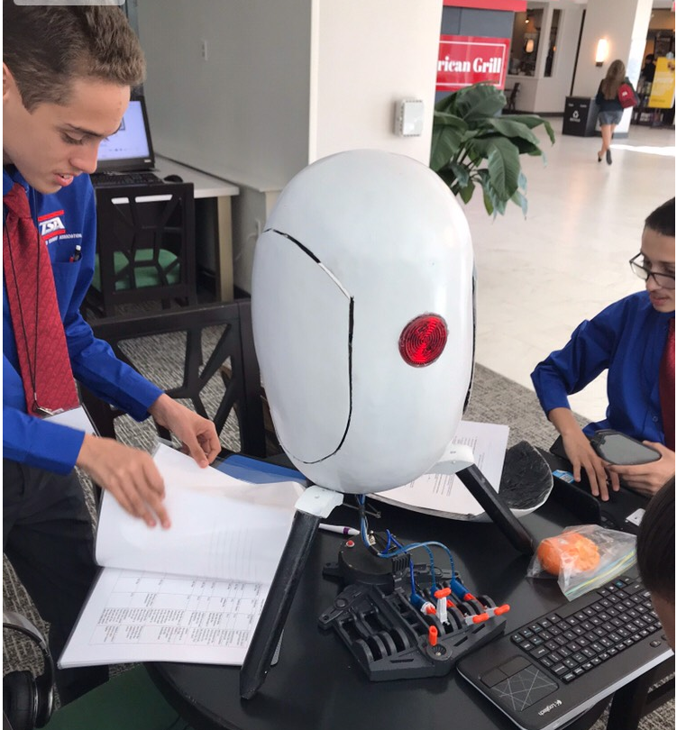 Two students working to program a robot.